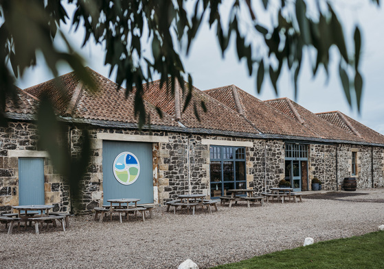 Pratis Barns exterior with round picnic tables